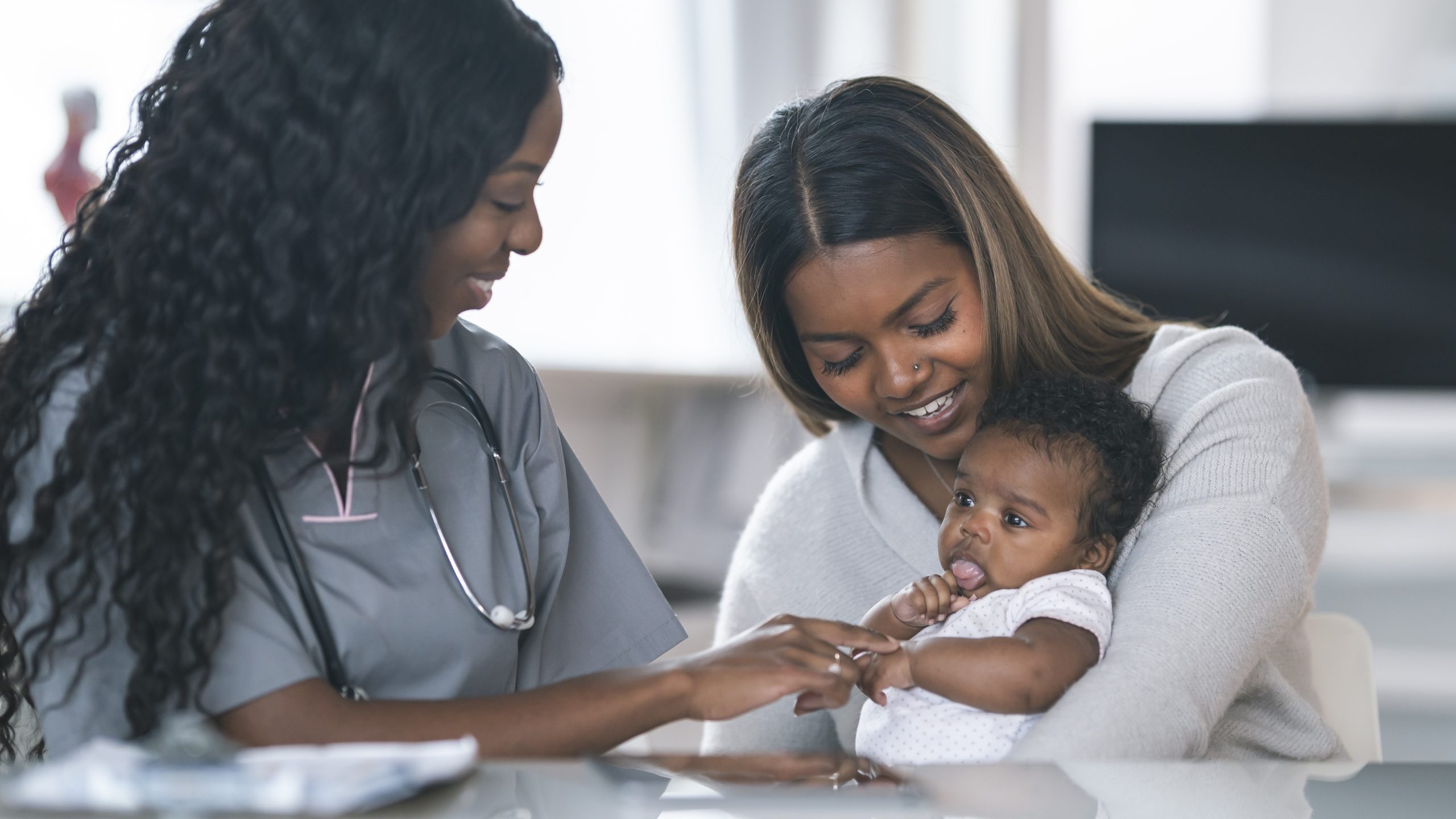 — title missing — Mom and baby visiting with health care provider