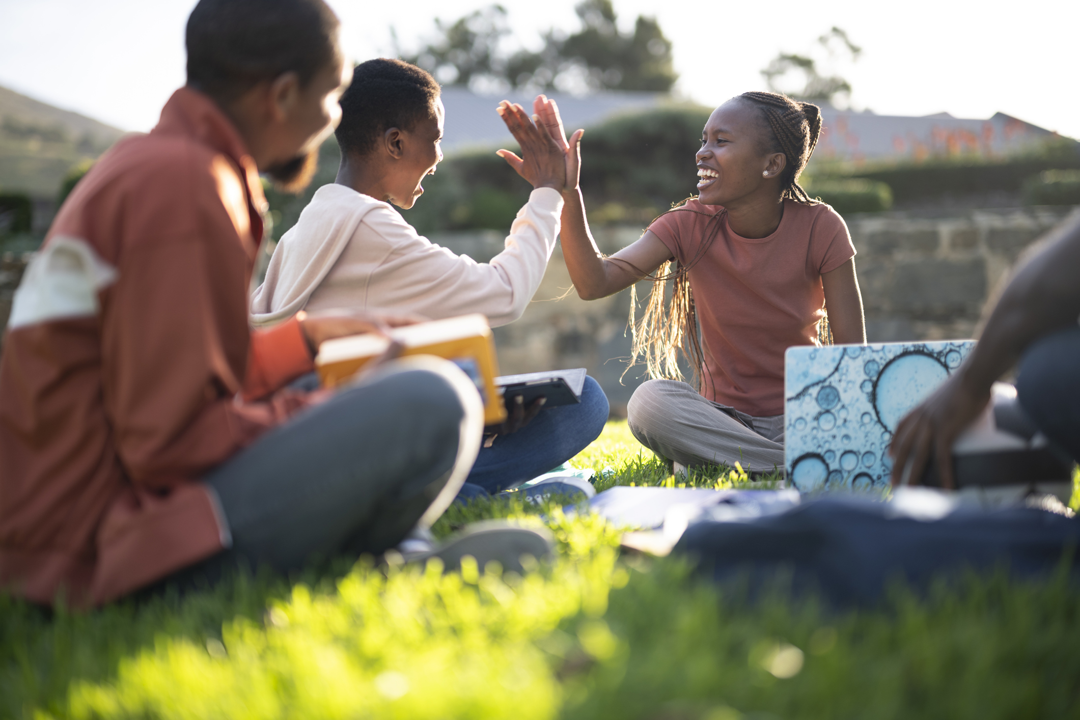 People sitting together on the grass outdoors.