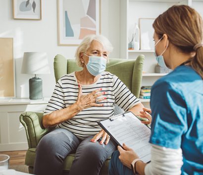 Older woman talking with her doctor.
