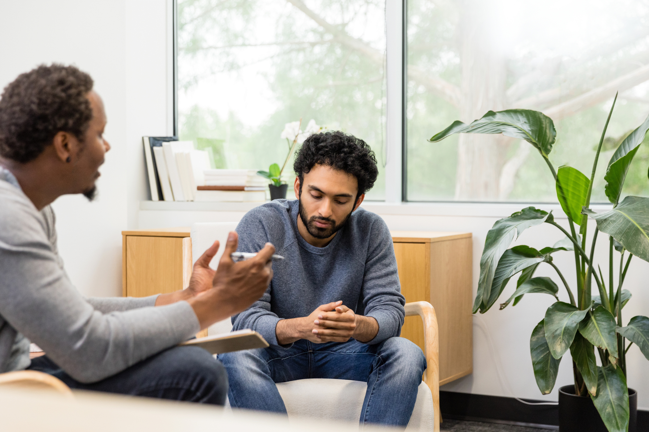 Care professional talking to man.
