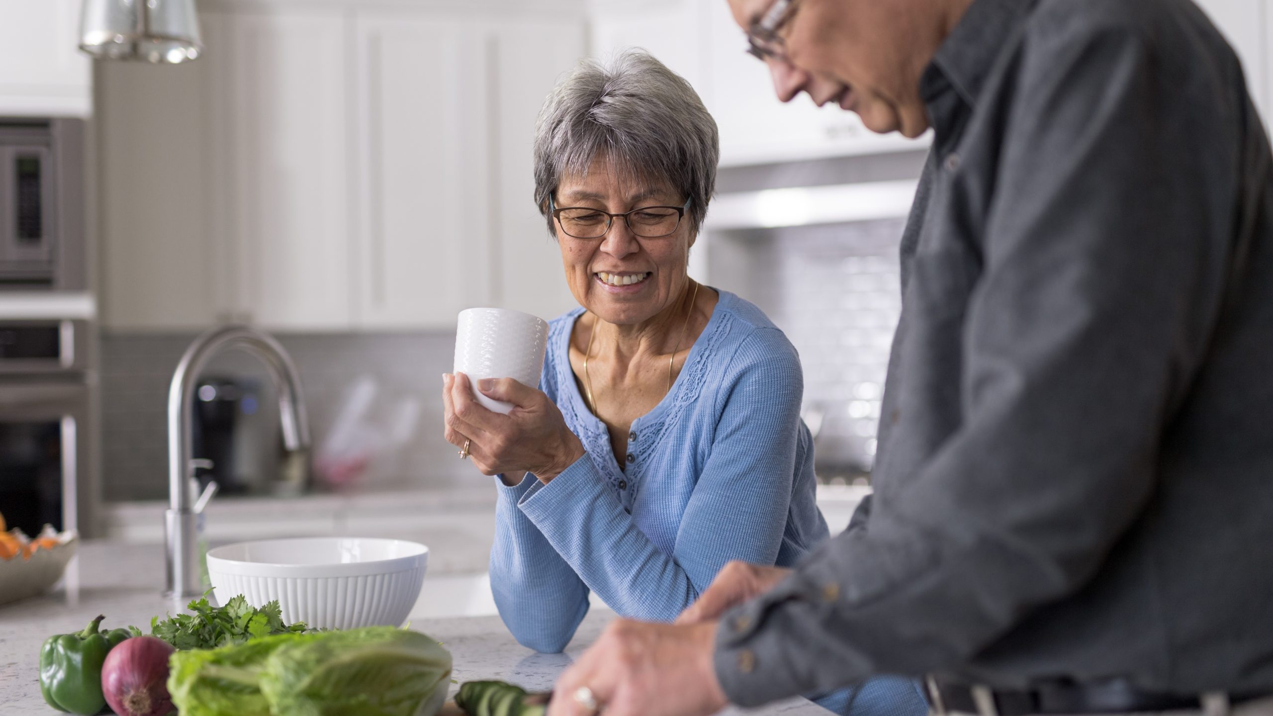 — title missing — Older man and woman cooking together
