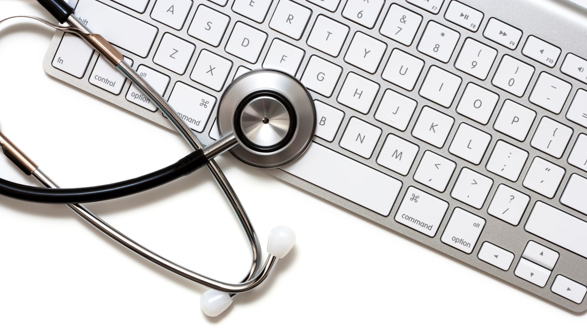 A stethoscope rests on a computer keyboard.