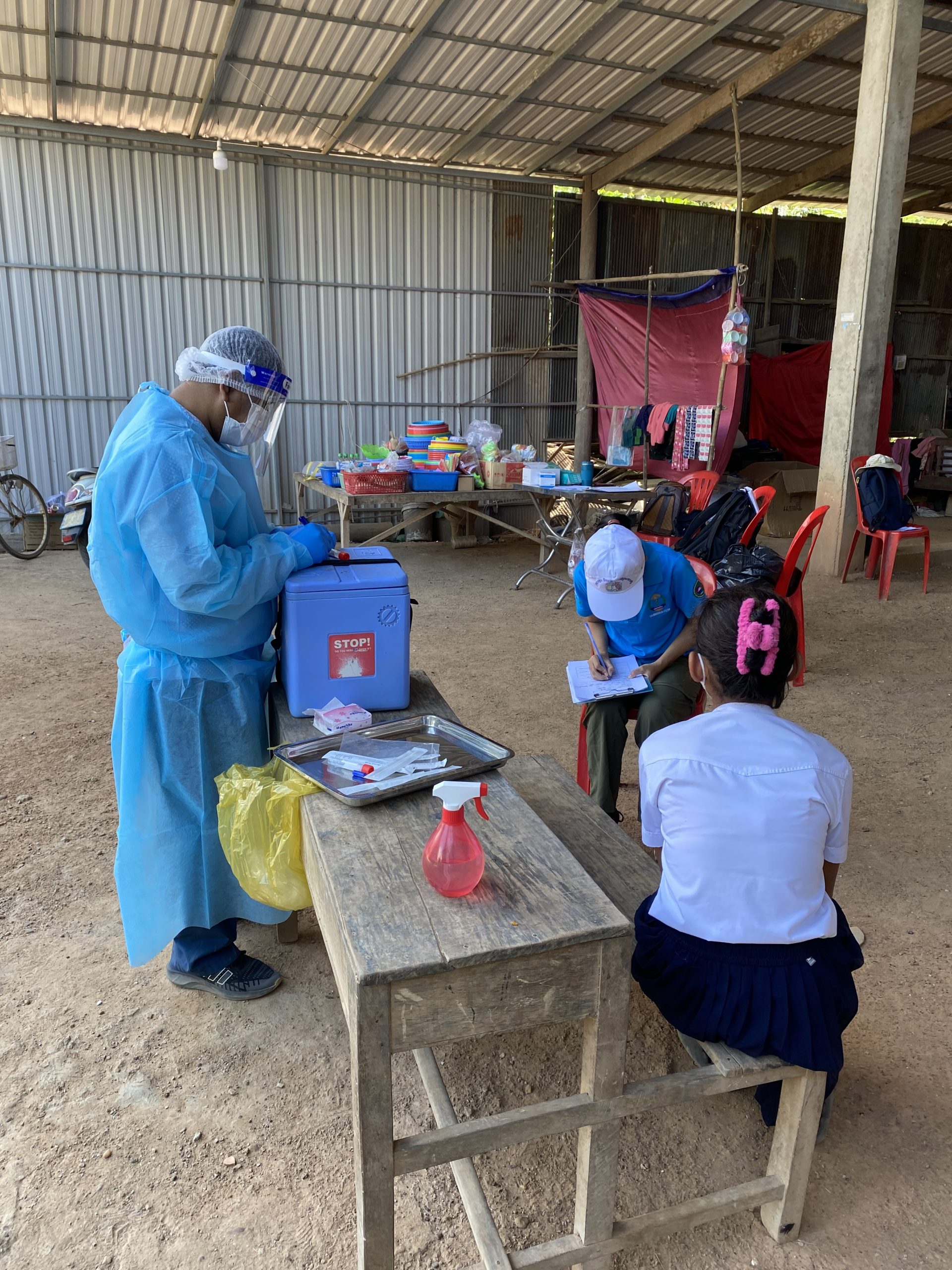 Swabbing close contacts in Cambodia, February 2023 Swabbing patients while wearing PPE