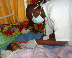 A flu surveillance nurse collects a sample from a child with acute respiratory illness at a local hospital in Rwanda. A flu surveillance nurse collects a sample from a child with acute respiratory illness at a local hospital in Rwanda.