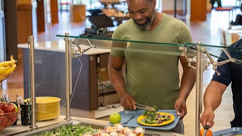 Man at a salad bar.