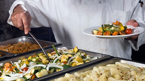 — title missing — Chef serving a plate of vegetables.