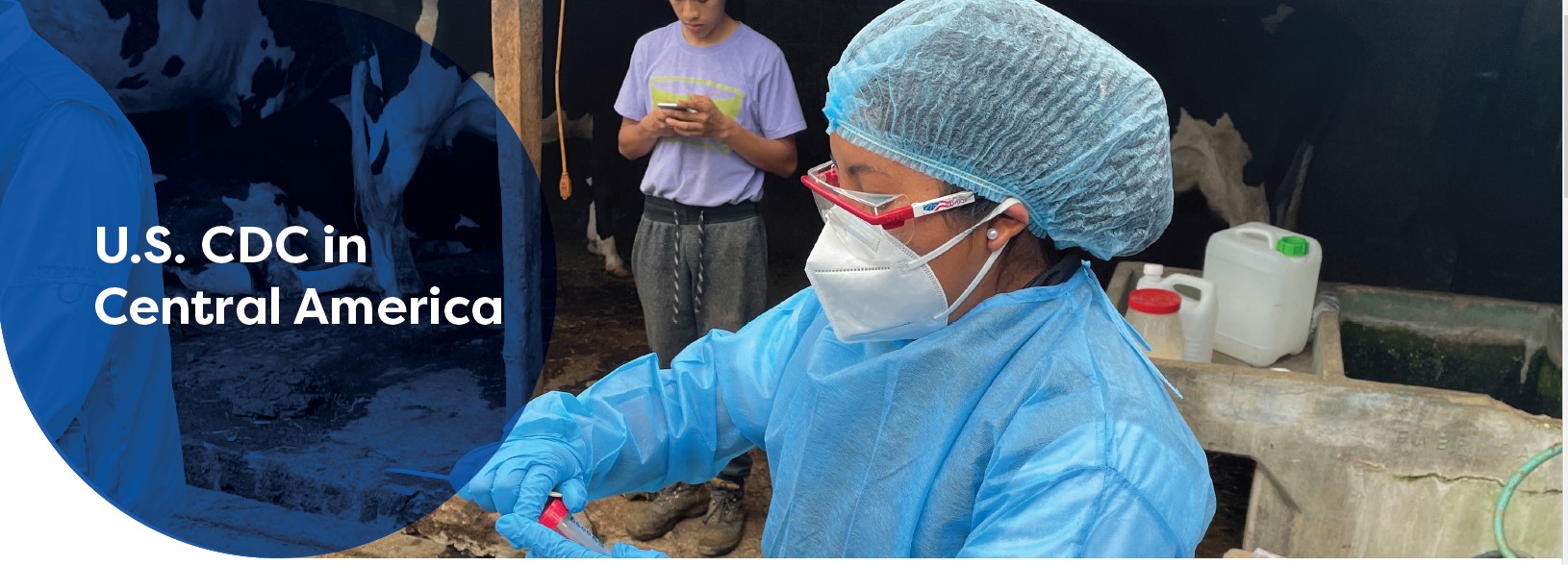 US CDC in Central America over blue circle. Woman dressed in PPE.
