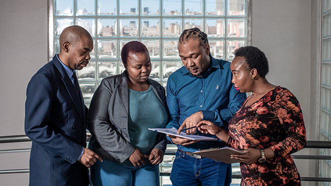 2024-05_Impact_Our-Approach_660x372 CDC and partners in South Africa discussing programs.