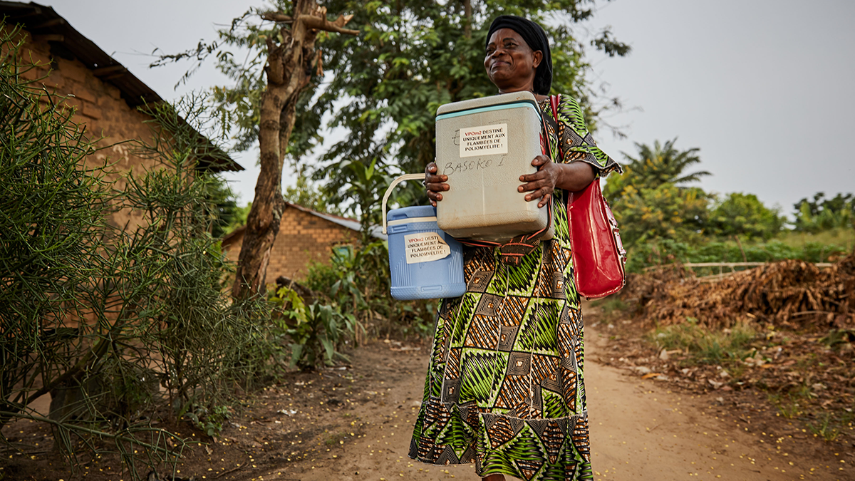 Woman delivering vaccines in coolers Woman delivering vaccines in coolers