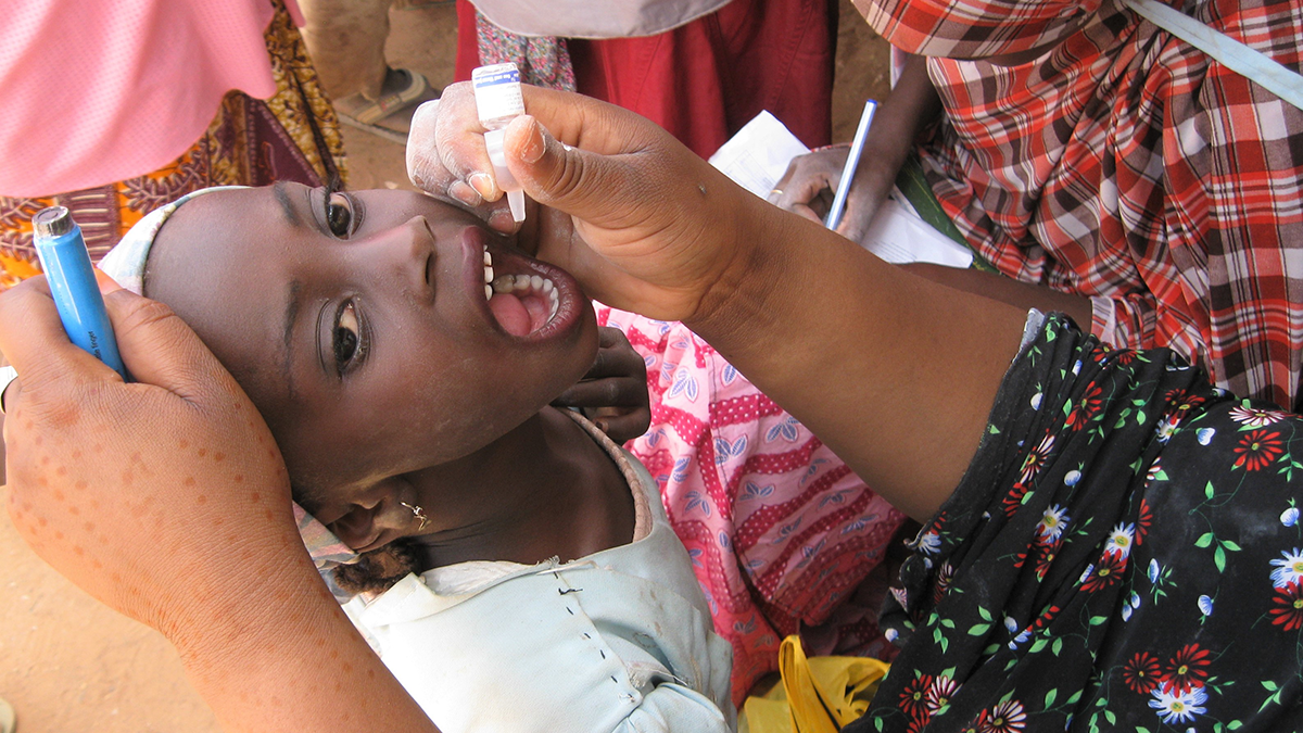 Girl receiving an oral vaccine Girl receiving an oral vaccine