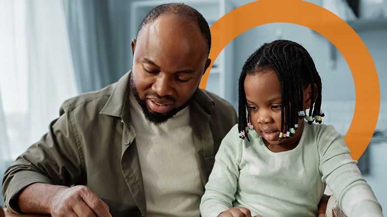Father and child work on a coloring book