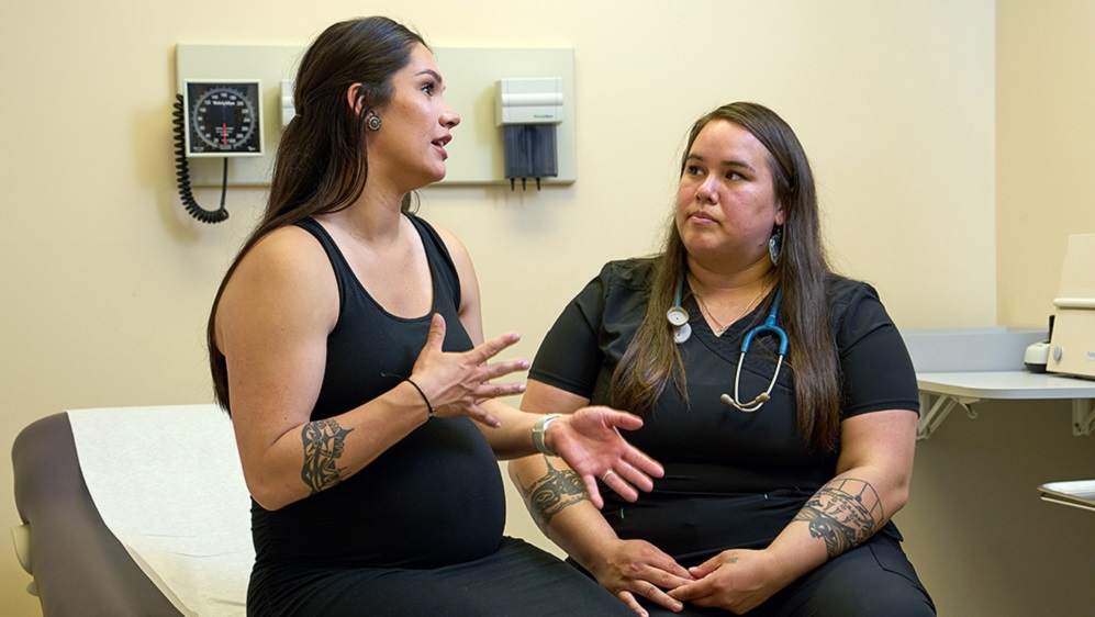 — title missing — Pregnant woman talking to health care professional.