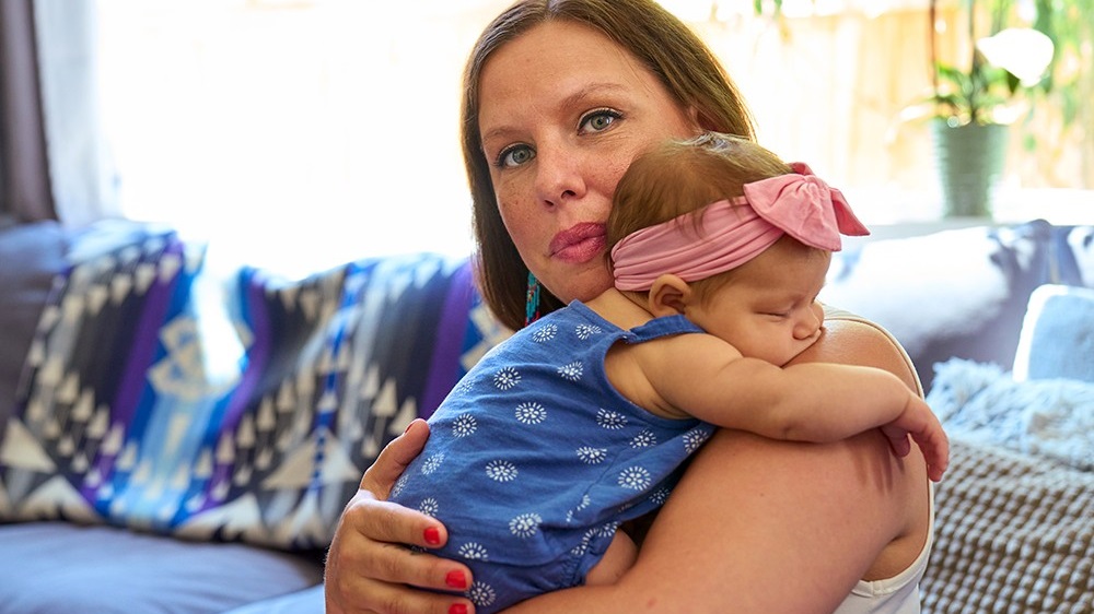 — title missing — woman holding baby