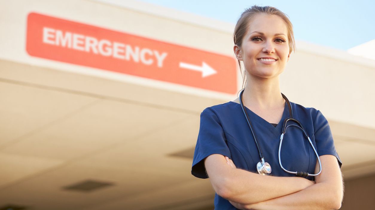 ER doc Doctor standing in front of emergency sign