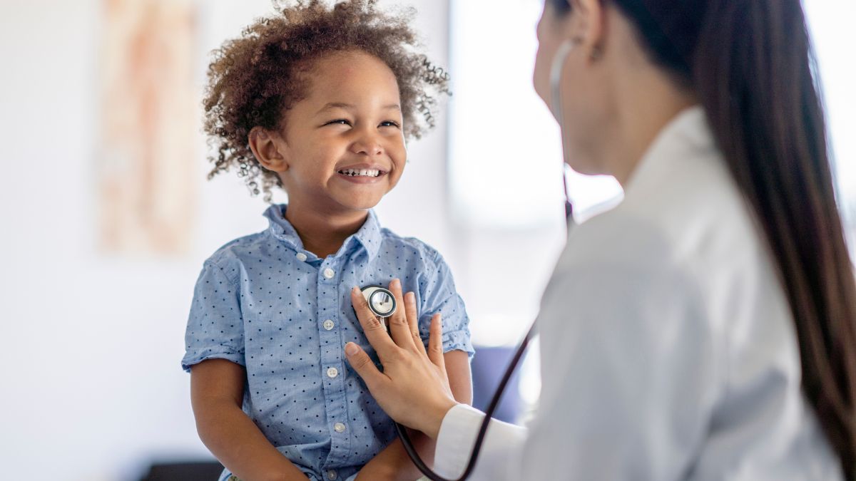 — title missing — Doctor listening to a child's heart