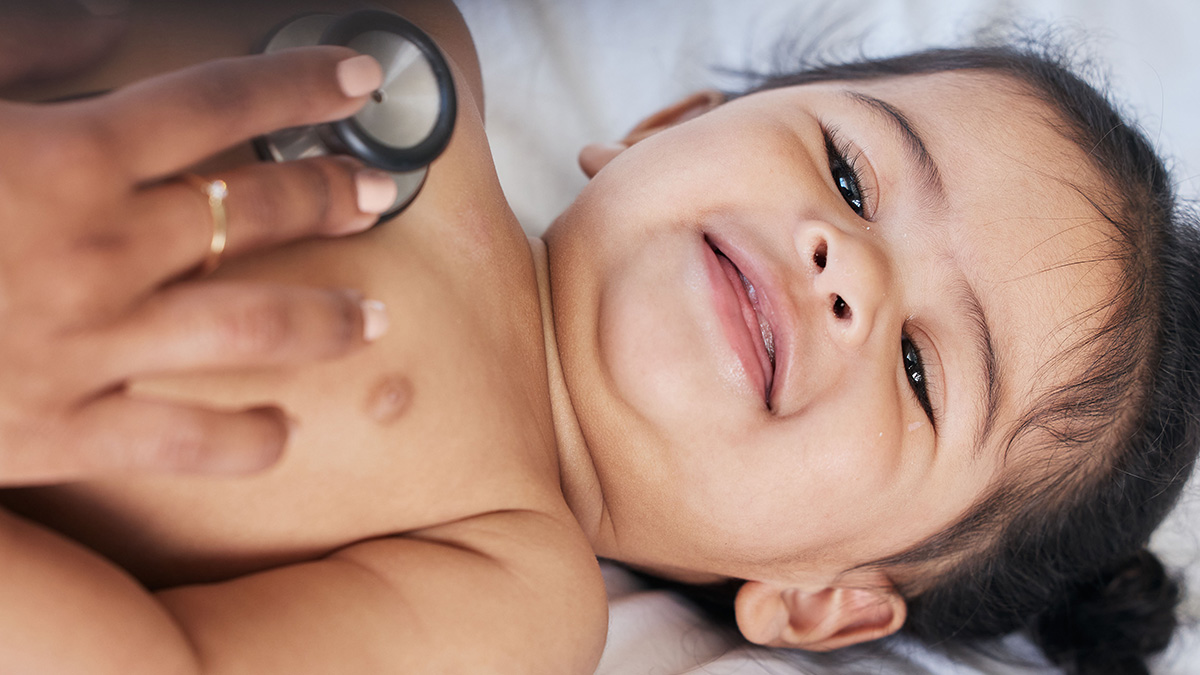 Doctor listening to hispanic baby's heart Doctor listening to baby's heart