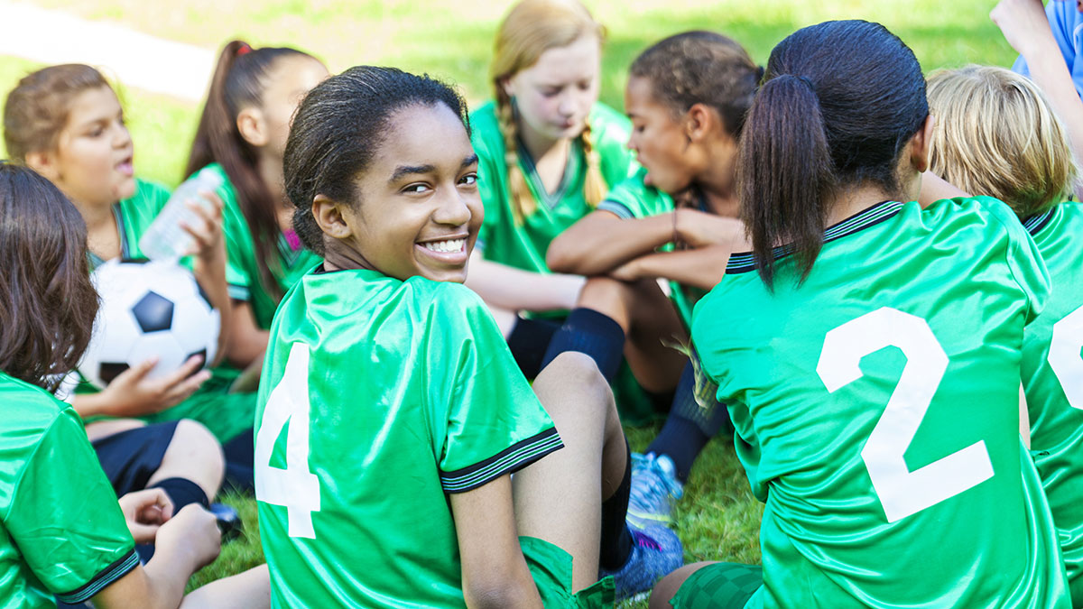 african-american-girl-smiling-with-her-soccer-team African American girl smiling with her soccer team