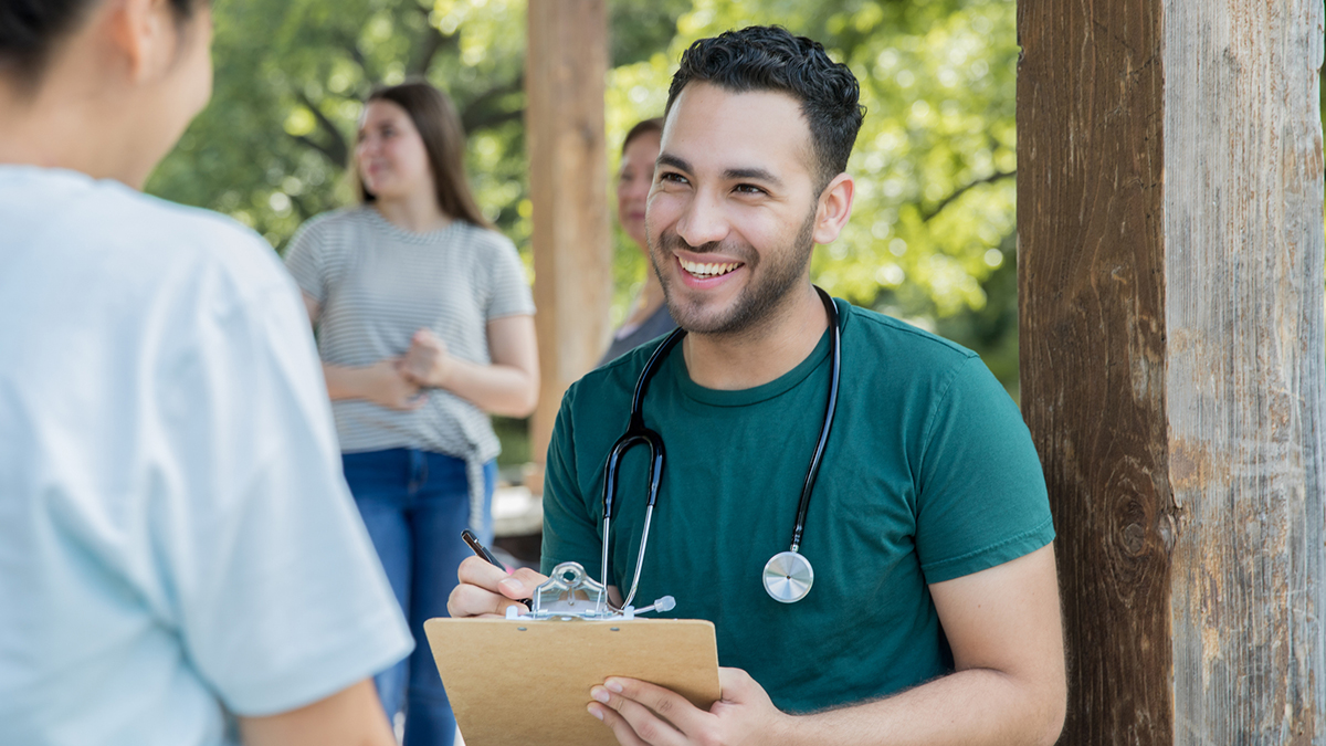 Hepatitis A Clinical Care and Treatment Thumbnail A patient speaking with a doctor outdoors while the doctor takes notes on a clipboard