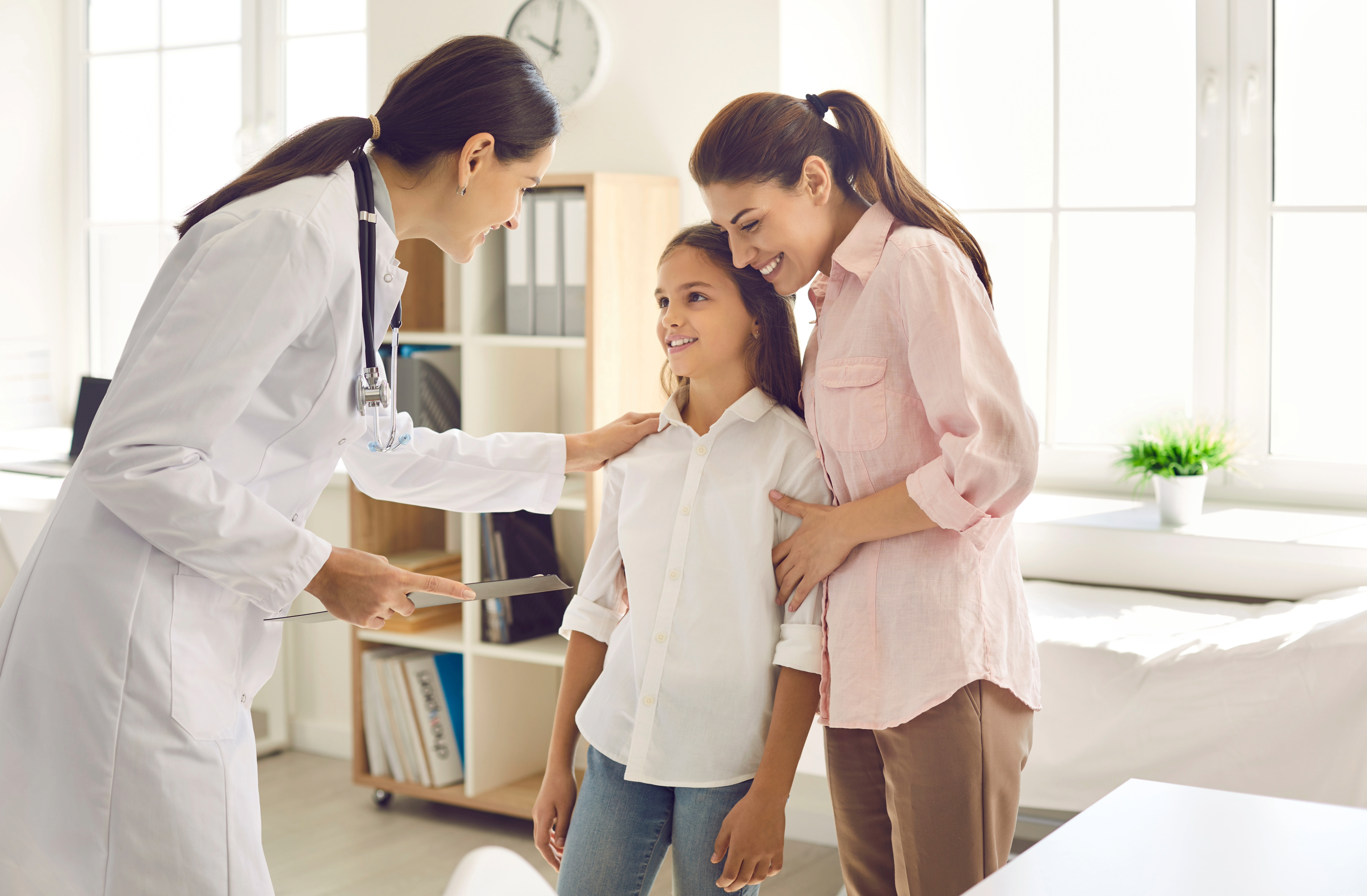 Doctor talking to parent and patient Healthcare provider talking to patient and parent.