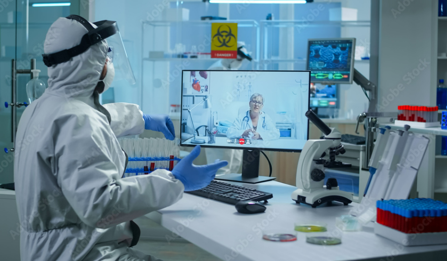 Lab Worker Public health lab worker in personal protective equipment on a video call with a healthcare provider