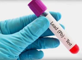 Blood sample A gloved hand holding a vial with a lead test.
