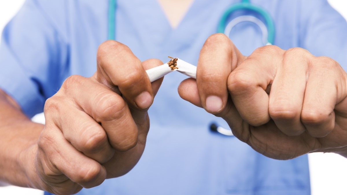 Doctor Breaks Cigarette un doctor rompiendo un cigarrillo por la mitad