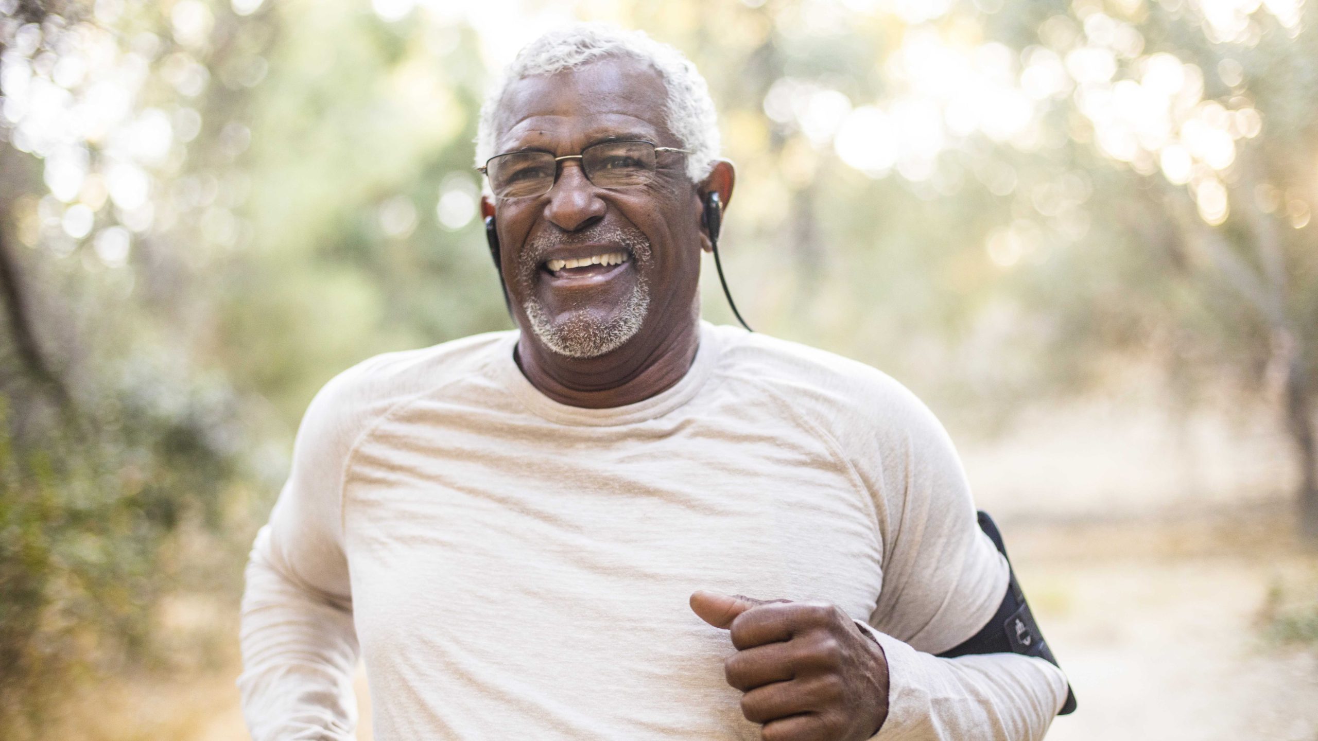 Older man running outside.