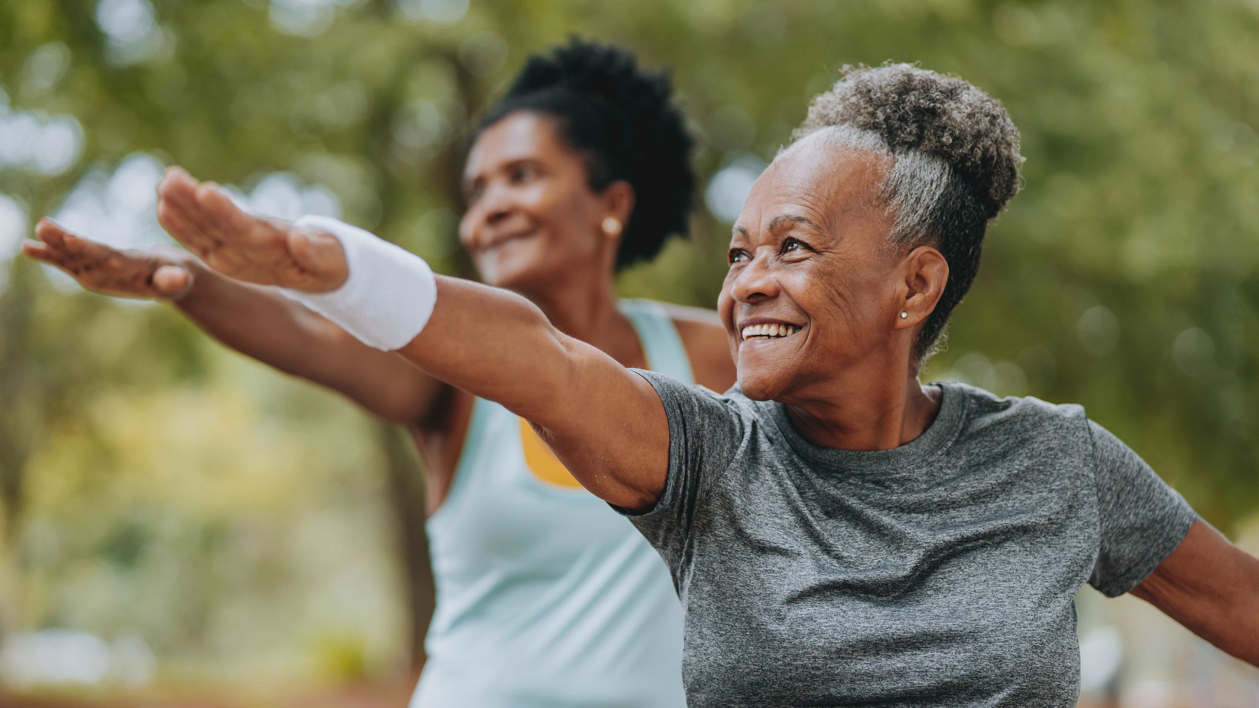 Older women doing Yoga outside.