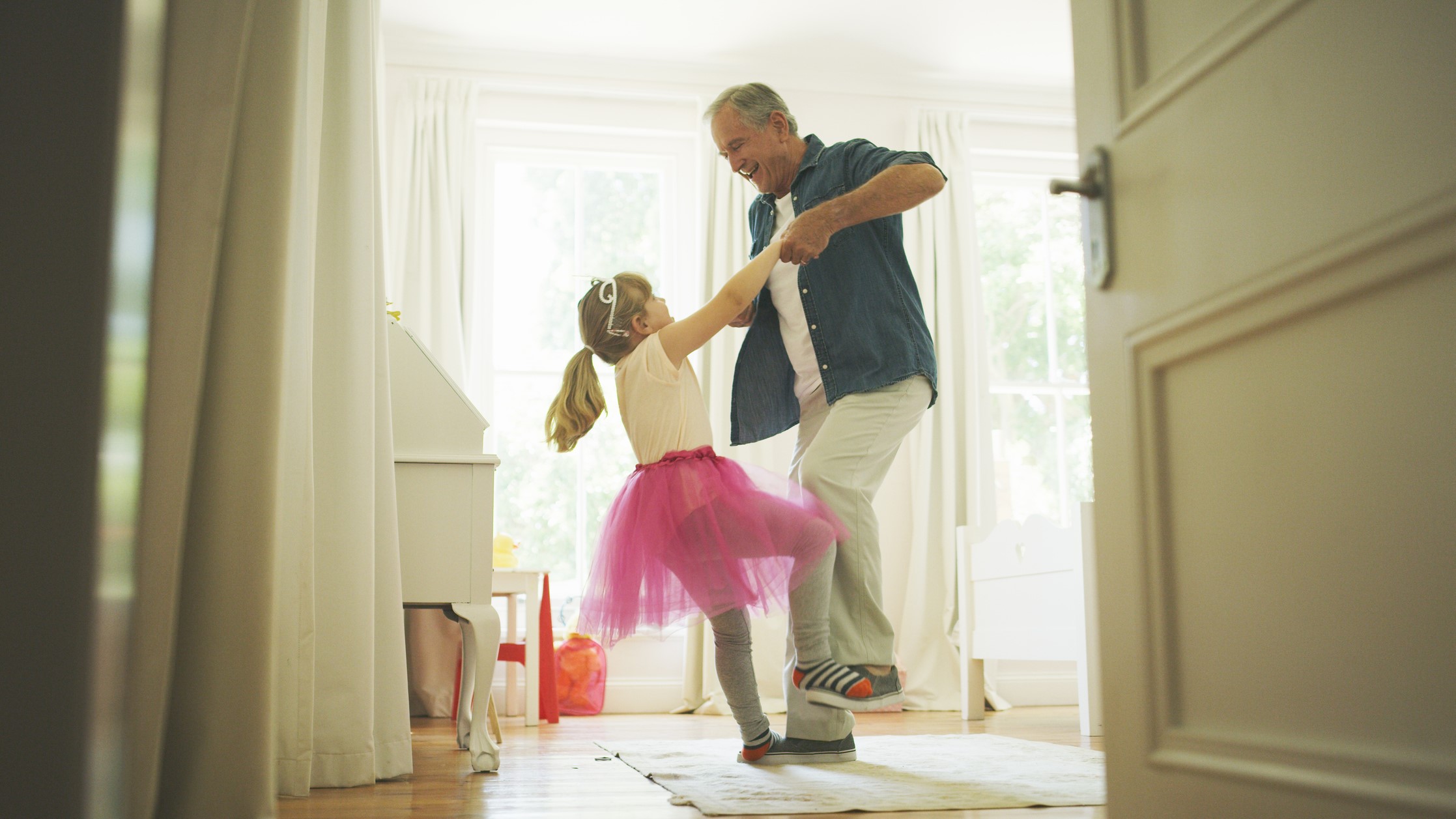 Grandfather dancing with his granddaughter.