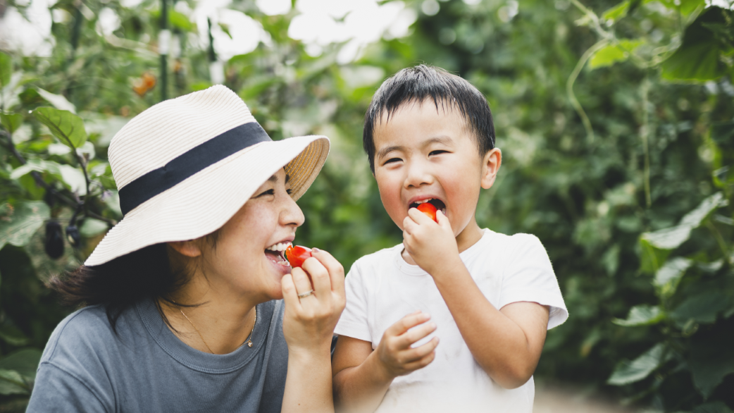 About Us DPH mom and child eating berries