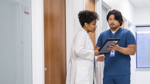 Doctors_Talking_Hospital_Hall Doctor and nurse talking in hospital hallway