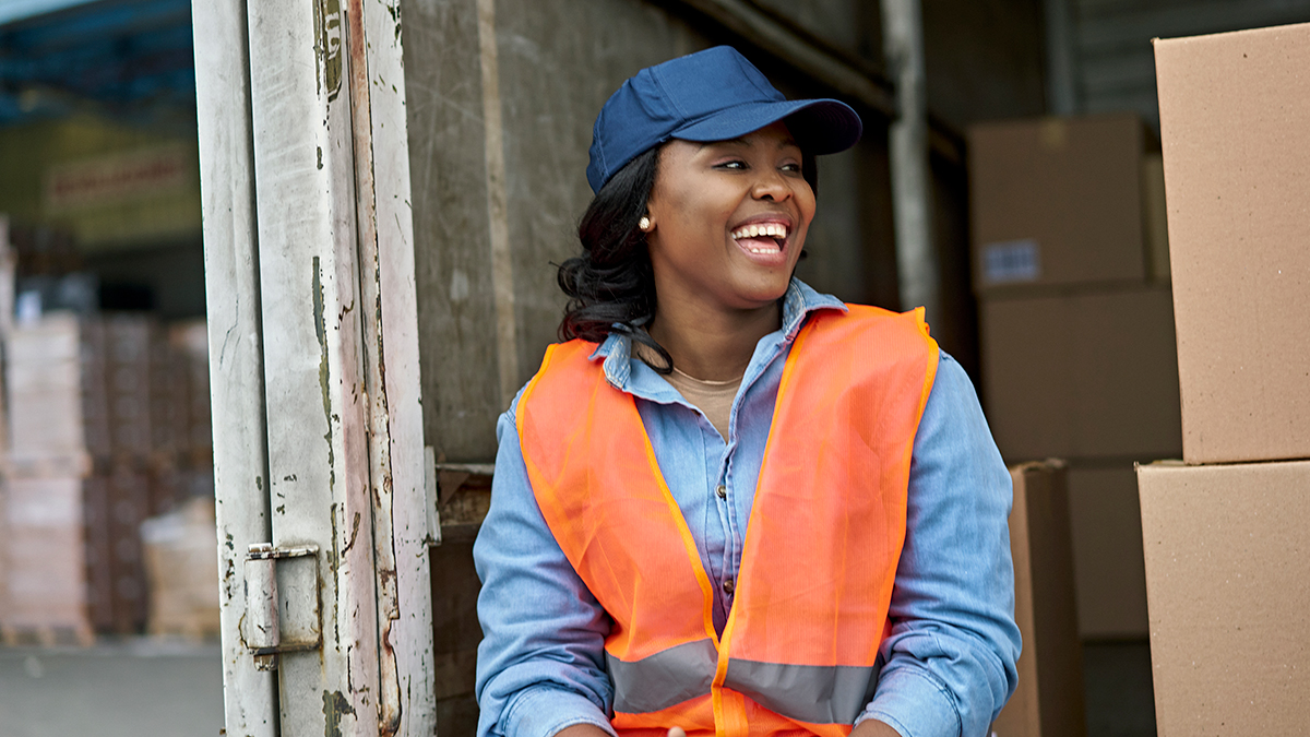 Delivery driver Woman delivering packages sitting in back of truck with boxes
