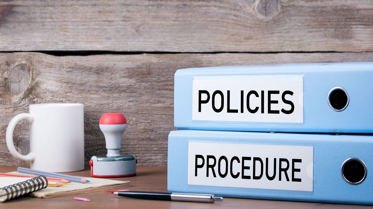— title missing — Stacked binders labelled "policies" and "procedures"