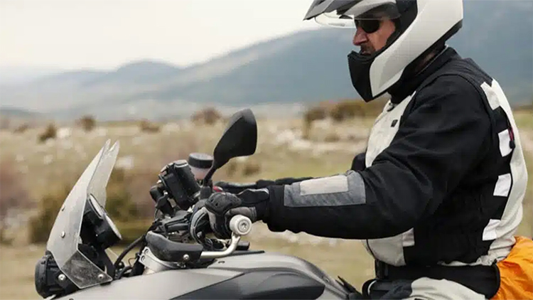 white_motorcycle Man on white motorcycle with helmet and padding
