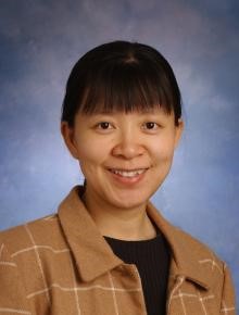 Professional portrait photograph of Mei Zhou