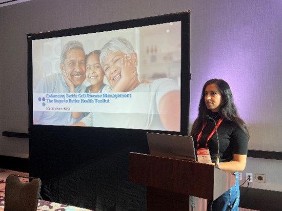 A person stands behind a podium presenting a slideshow
