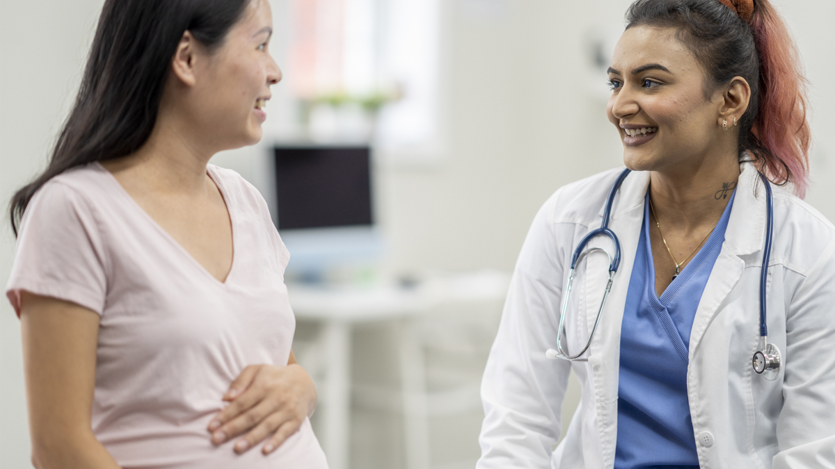 Pregnant woman with healthcare provider Pregnant woman with healthcare provider