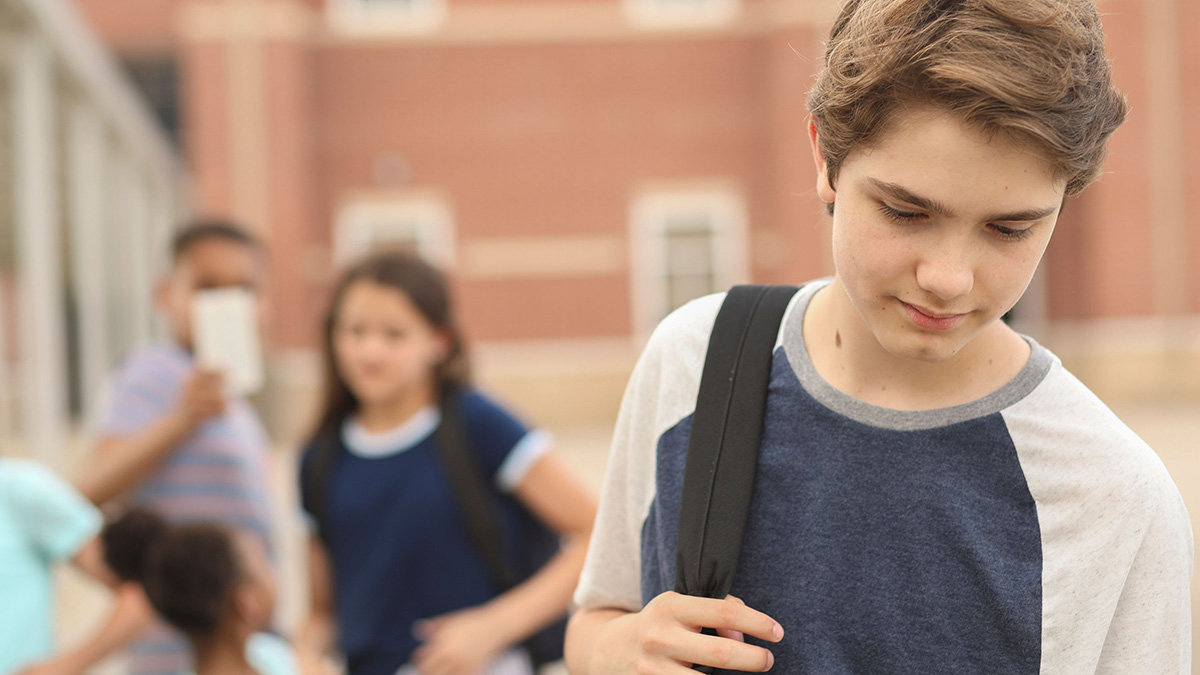 Young boy being bullied at school.