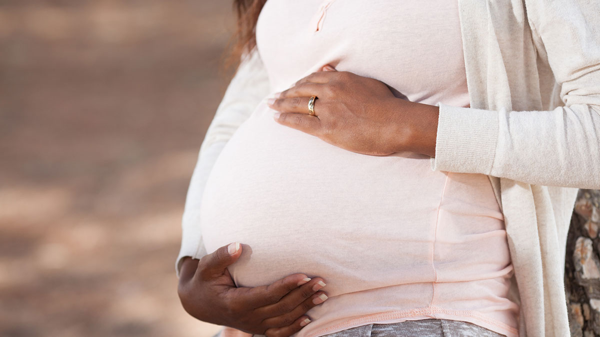 Woman holding her belly.