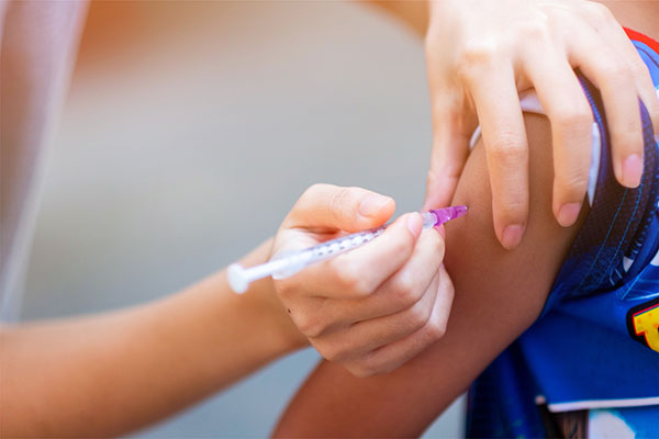a health care provider giving a patient a vaccine.
