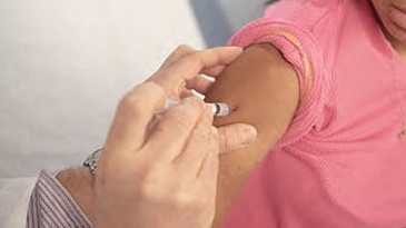 A healthcare provider administers a vaccine.